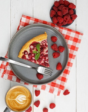 Una taza de café maridada con un postre de fresas